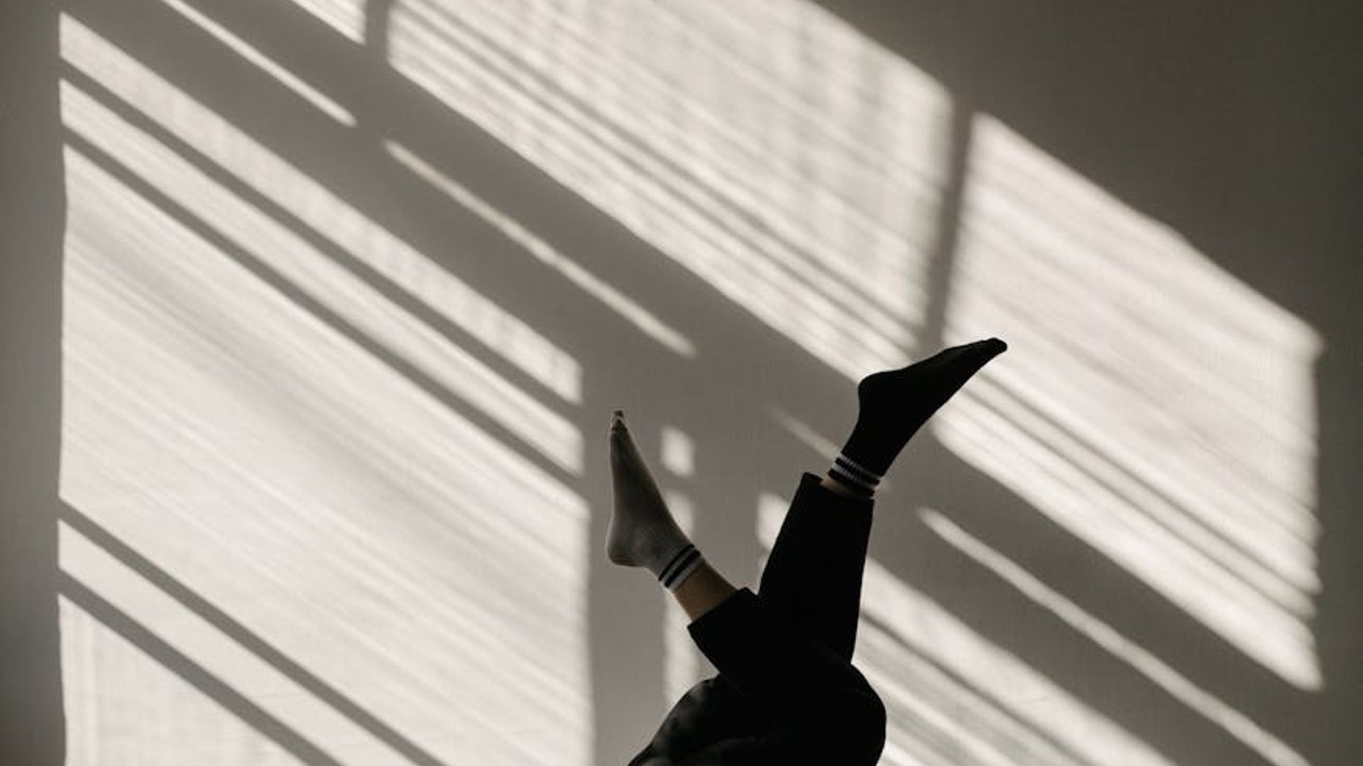 Minimalist yoga studio with soft morning sunlight streaming in.